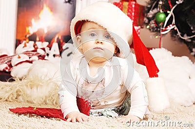 Little happy Christmas girl in santa s hat