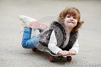Little hipster girl with skateboard portrait
