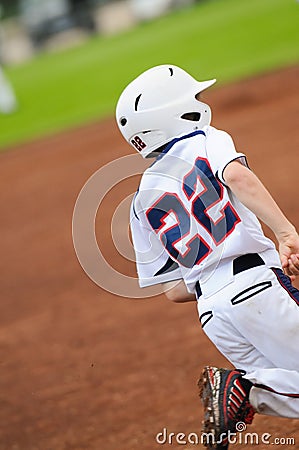 Little league baseball player running