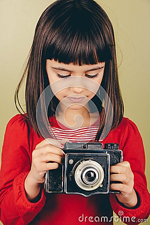 Little retro photographer with an old camera