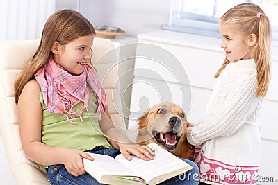 Little sisters with pet dog at home