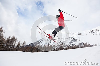 Little skier jumping in the snow.
