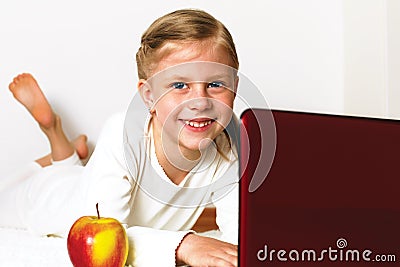 Little student girl with laptop pc at home