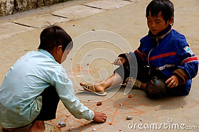 Little Vietnamese boys playing games on the path