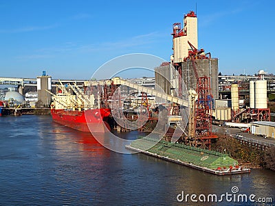 Loading a cargo ship, grain elevators Portland OR.