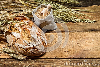 Loaf of bread and a bag with grains