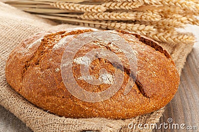Loaf of bread with wheat ears