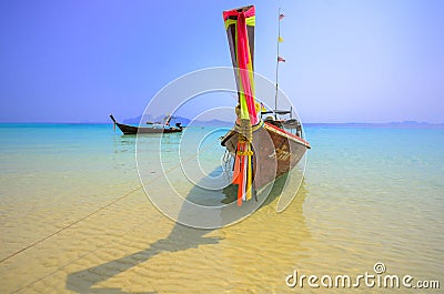 The local boat in south of thailand called long tail boat in the beautiful crystal clear sea water with blue sky