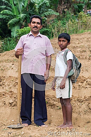 Local farmer and his son stand on tea plantation