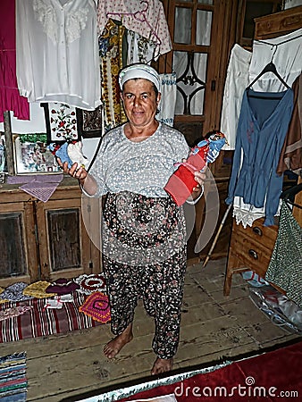 Local village woman shows fabric dolls he sells