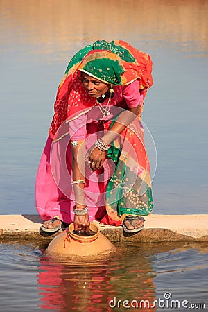 Local woman getting water from reservoir, Khichan village, India