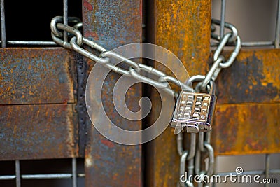Lock with chain on rusty gate