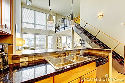 Loft modern apartment with wood kitchen and staircase.