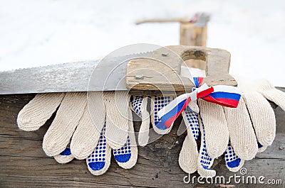 Log, handsaw and work gloves