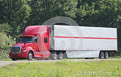 Lone tractor-trailer on an interstate highway.