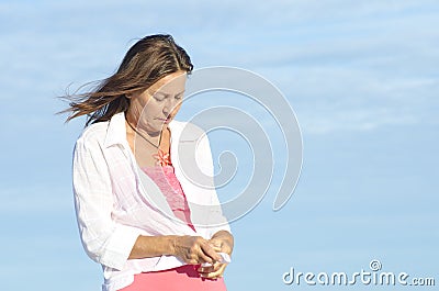 Lonely depressed senior woman sky background