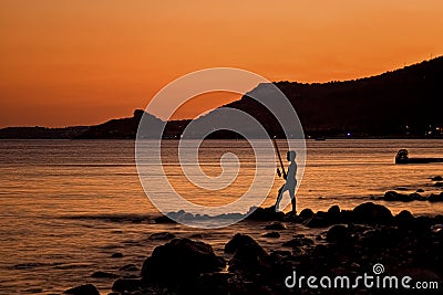 Lonely Fisherman At Sunset