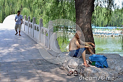 The lonely old man enjoy cool air in the park