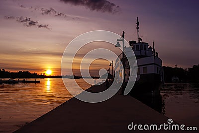 Lonely Ship Docked at the Wharf during Sunset