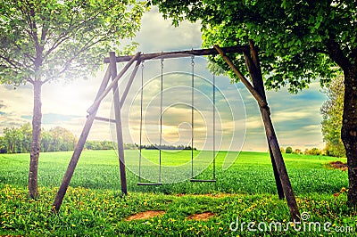 Lonely swing at summer sunset