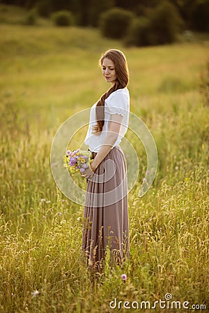 Lonely woman with bouquet of flowers