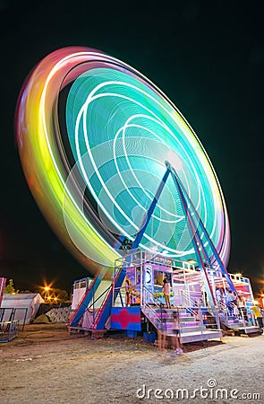 Long exposure picture of a Ferrys wheel rotating in a small local amusement park