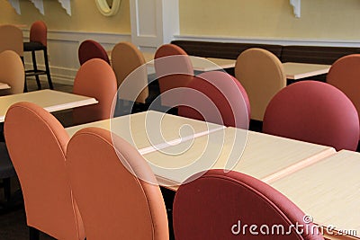Long tables with colorful chairs in meeting room