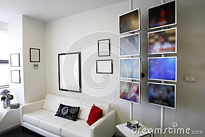 Lounge room with white couch and lcd displays