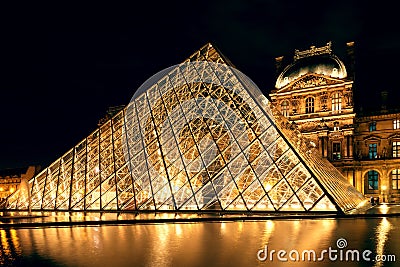 The Louvre museum at night in Paris