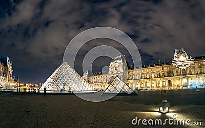 The Louvre museum at night in Paris