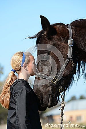 Girl kissing her pony