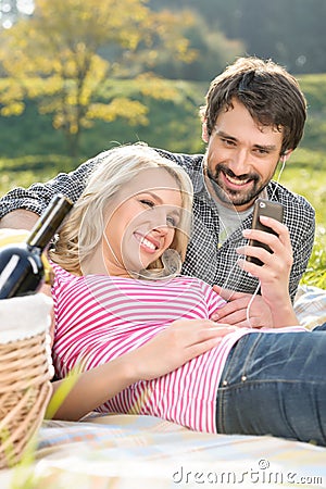 We love this song. Loving young couple listening to the music on