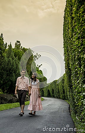 Lovely couple walk together in the garden2