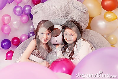 Lovely girlfriends posing with big teddy bear