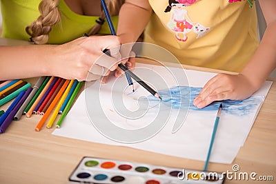 Lovely happy family drawing and painting at home