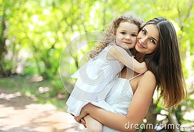Lovely mom and daughter in warm sunny summer day