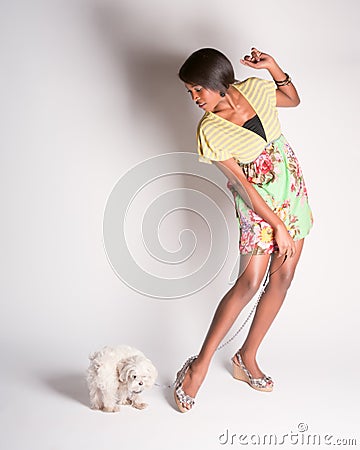 Lovely pinup girl walking a dog