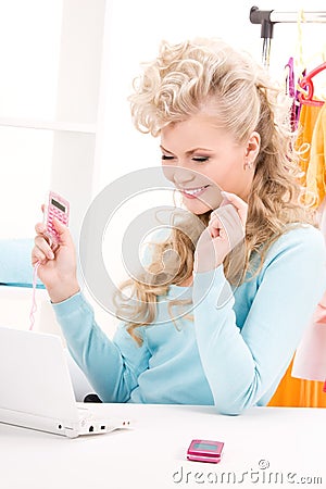Lovely woman with calculator and computer