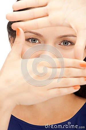 Lovely woman creating a frame with fingers