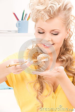 Lovely woman eating sushi