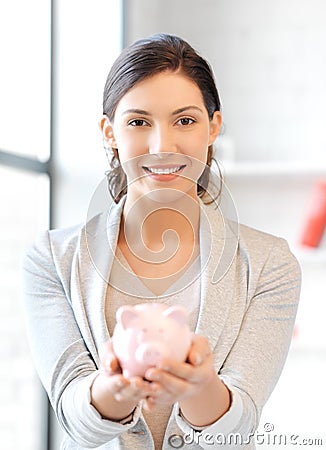 Lovely woman with piggy bank
