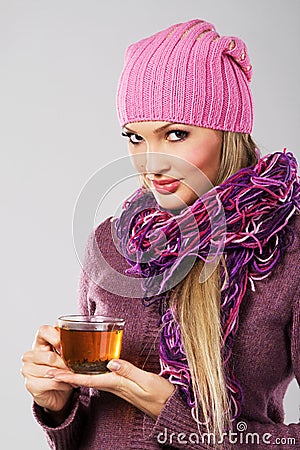 Lovely woman in warm clothing with cup of tea