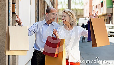 Lovers couple having shopping tour in city and smiling
