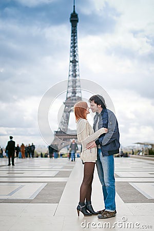 Loving couple kissing near the Eiffel Tower in Paris