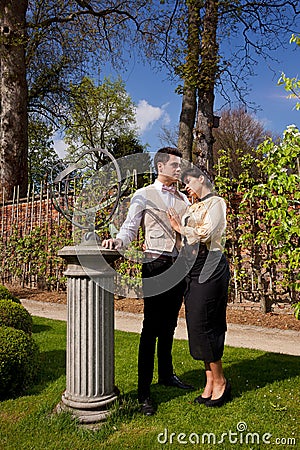 Loving couple in Victorian clothing, column and su