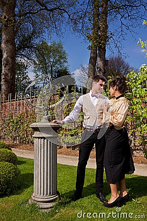 Loving couple in Victorian clothing, pillar and su