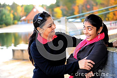 Loving mother and daughter enjoying autumn