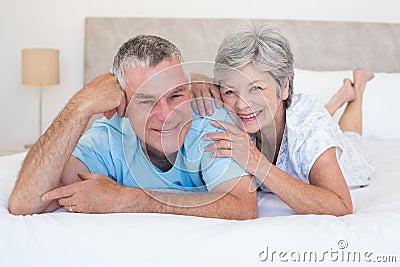 Loving senior couple lying in bed