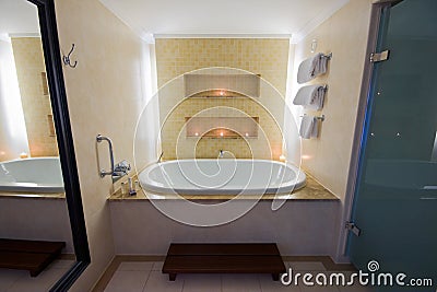Luxury bathroom with large bath and lit candles
