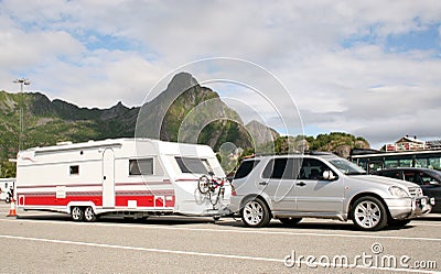 Luxury car caring caravan with bikes on